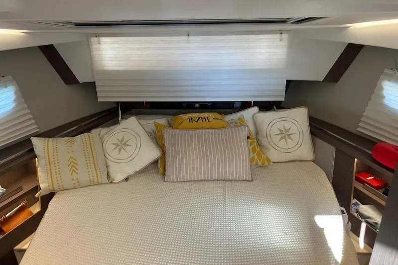 Yacht Photos Pics 2022 Sealine C335V cabin interior with cozy bed and decorative pillows.