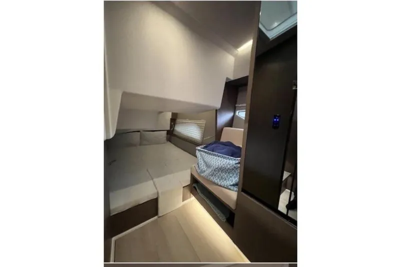  Yacht Photos Pics Interior cabin of 2022 Sealine C335V yacht, featuring a cozy bed and modern design.