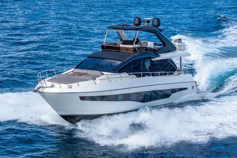  Yacht Photos Pics 2024 Astondoa 66 Flybridge yacht cruising on open sea.