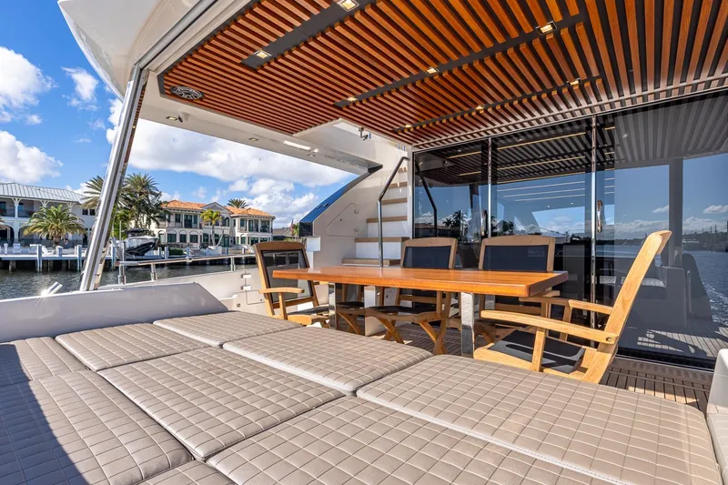  Yacht Photos Pics 2024 Astondoa 66 Flybridge yacht with luxurious outdoor seating and dining area.