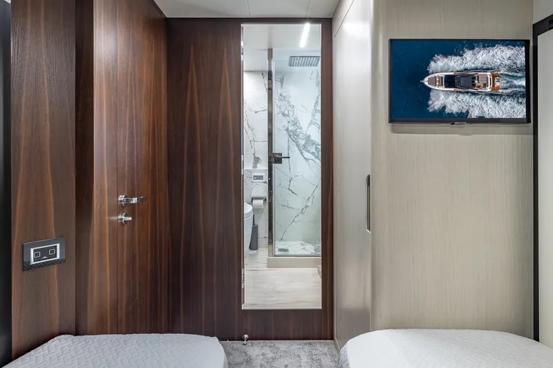  Yacht Photos Pics Luxurious interior of 2024 Astondoa 66 Flybridge yacht with modern bathroom and TV.