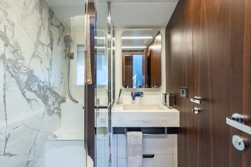 Yacht Photos Pics Luxurious bathroom in 2024 Astondoa 66 Flybridge yacht with marble accents and modern fixtures.