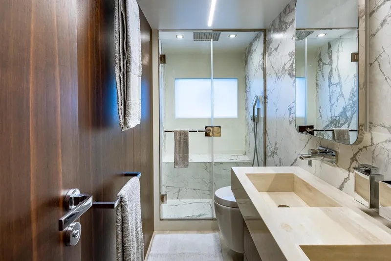  Yacht Photos Pics Luxurious bathroom in 2024 Astondoa 66 Flybridge yacht with marble accents and modern fixtures.