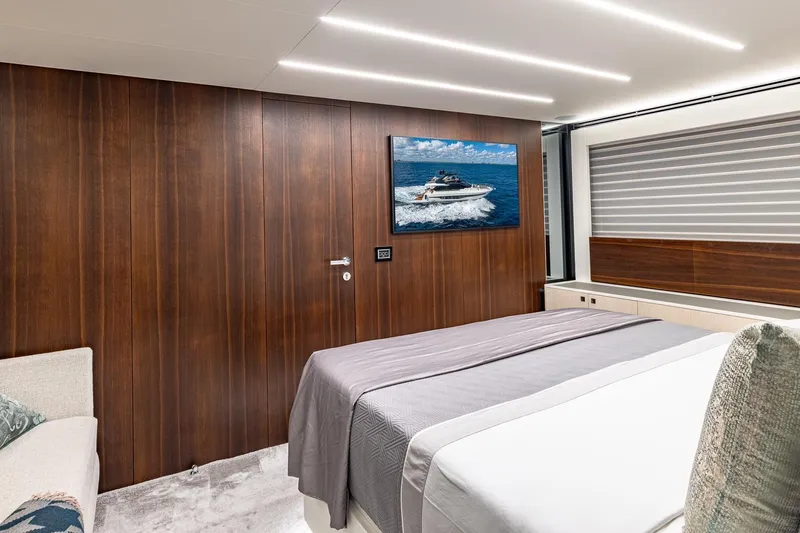  Yacht Photos Pics Luxurious bedroom interior on 2024 Astondoa 66 Flybridge yacht with modern wood paneling.