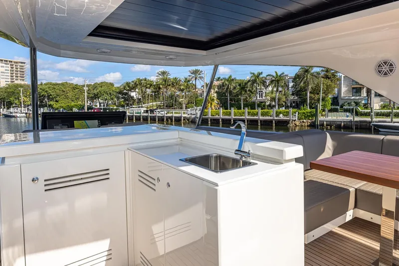  Yacht Photos Pics 2024 Astondoa 66 Flybridge yacht interior with sleek kitchenette and seating area.