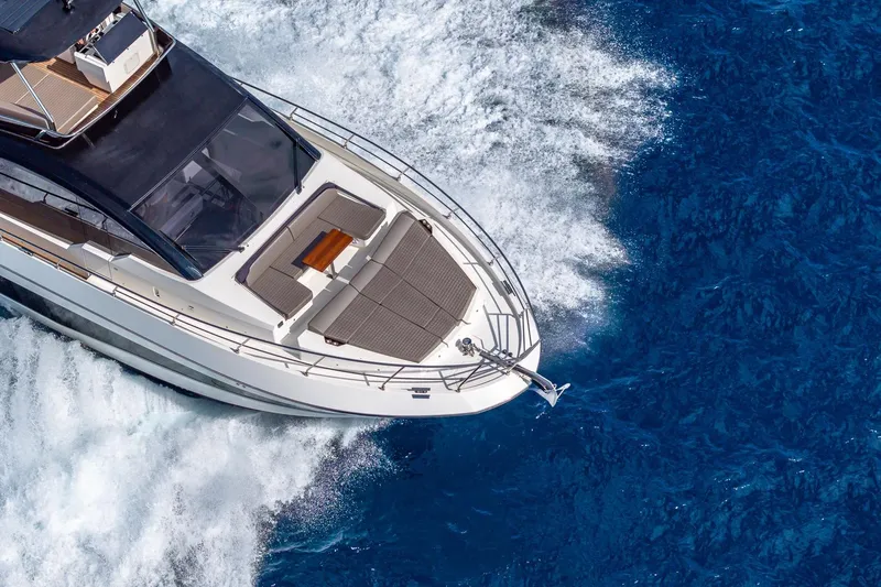  Yacht Photos Pics 2024 Astondoa 66 Flybridge yacht cruising on vibrant blue ocean waters.