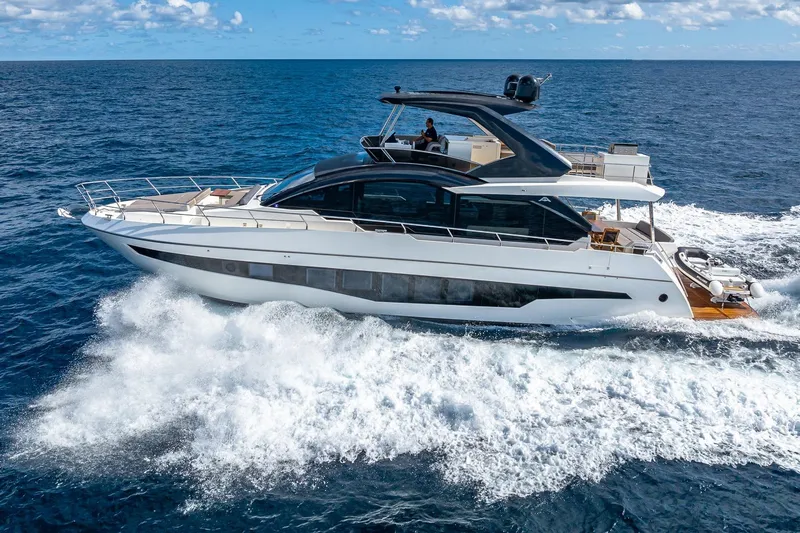  Yacht Photos Pics 2024 Astondoa 66 Flybridge yacht cruising on open ocean waters.