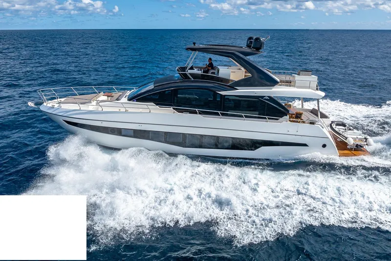  Yacht Photos Pics 2024 Astondoa 66 Flybridge yacht cruising on open sea under clear skies.