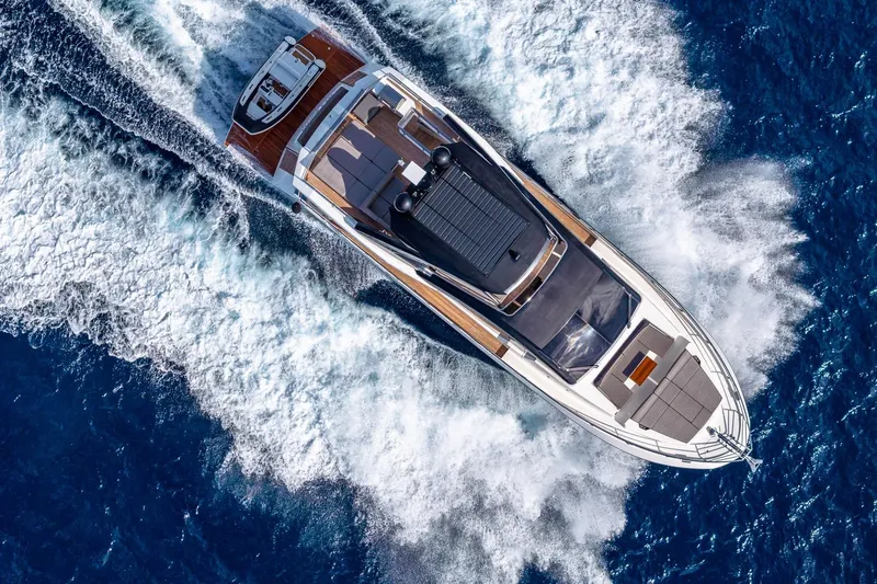  Yacht Photos Pics 2024 Astondoa 66 Flybridge yacht cruising on open blue sea, aerial view.