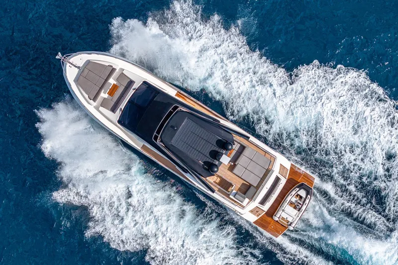  Yacht Photos Pics Aerial view of 2024 Astondoa 66 Flybridge yacht cruising on blue ocean waters.