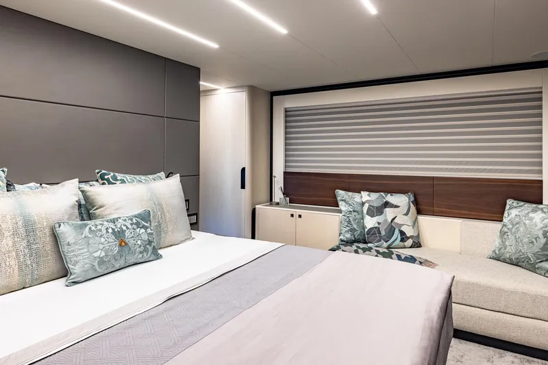  Yacht Photos Pics Luxurious bedroom interior of 2024 Astondoa 66 Flybridge yacht with elegant decor and plush pillows.