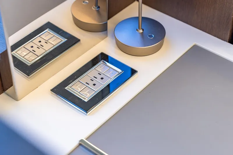  Yacht Photos Pics 2024 Astondoa 66 Flybridge interior detail with modern electrical outlet and sleek lamp design.