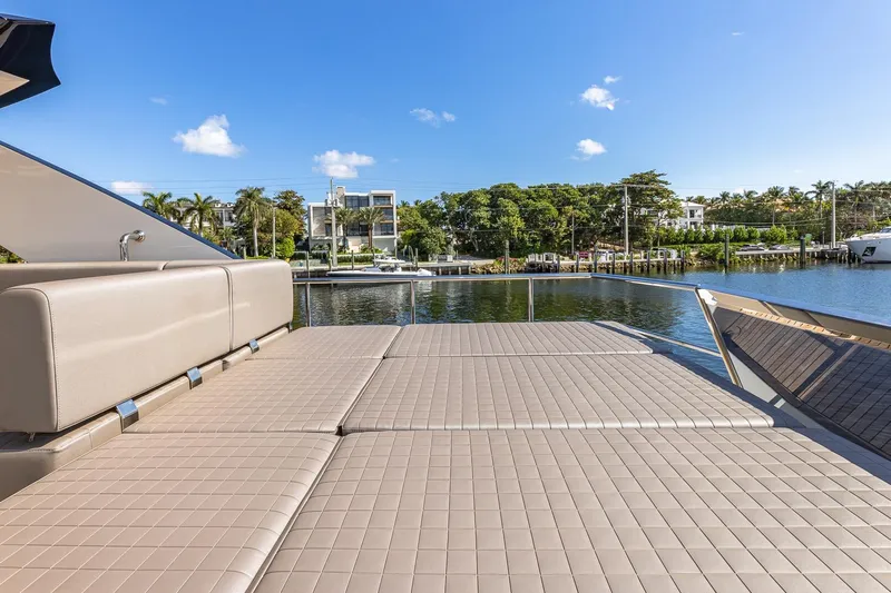  Yacht Photos Pics Luxurious 2024 Astondoa 66 Flybridge yacht with spacious sun deck, docked by serene waterfront.