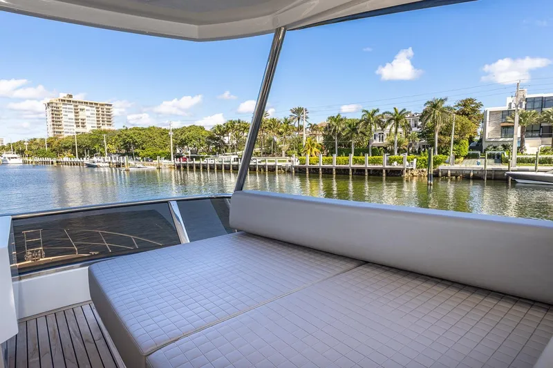  Yacht Photos Pics 2024 Astondoa 66 Flybridge yacht interior with waterfront view, featuring luxurious seating.