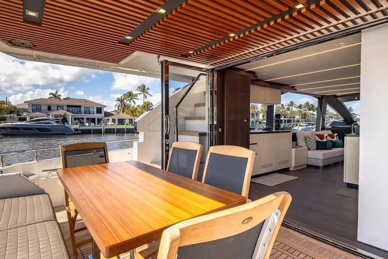  Yacht Photos Pics Astondoa 66 Flybridge 2024 yacht interior with elegant dining area and waterfront view.