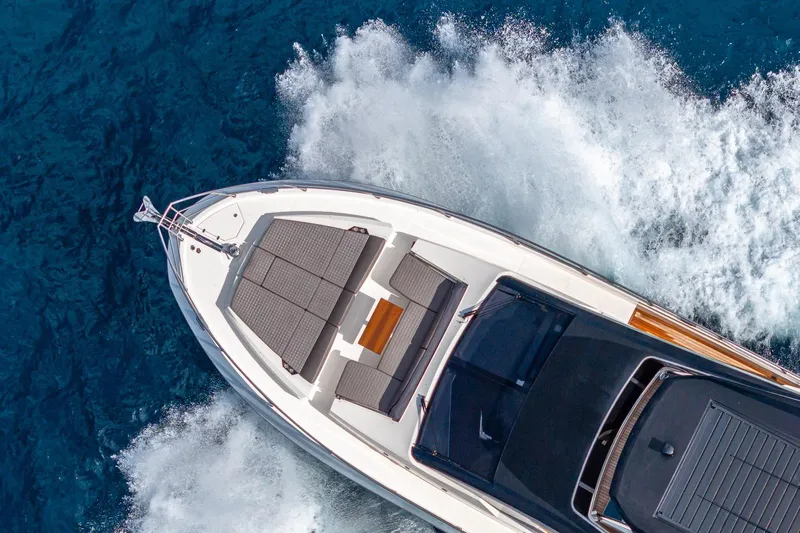  Yacht Photos Pics 2024 Astondoa 66 Flybridge yacht cruising on blue ocean waters.