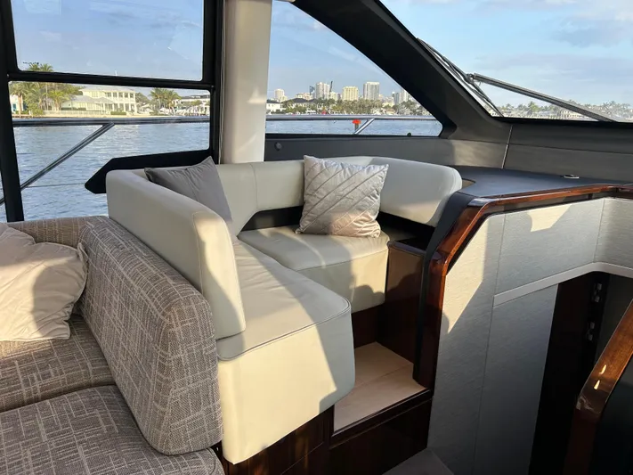 Fairline Squadron Yacht Photos Pics Luxurious interior of 2024 Fairline Squadron 68 yacht with elegant seating and waterfront view.