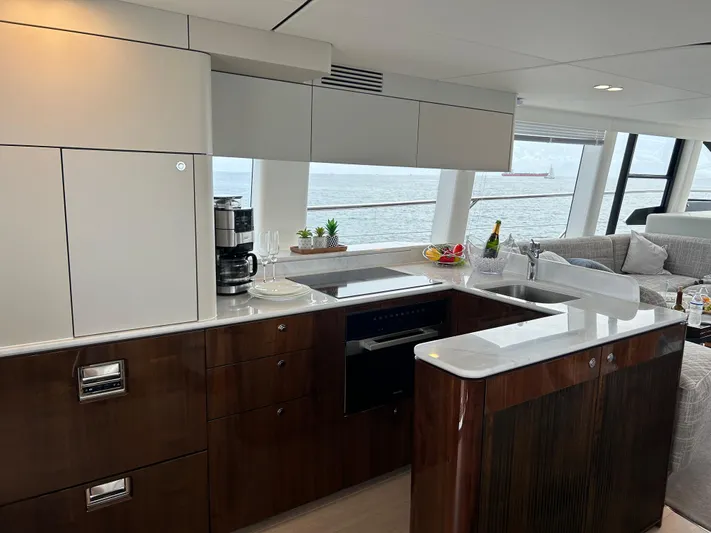 Fairline Squadron Yacht Photos Pics Luxurious kitchen interior of 2024 Fairline Squadron 68 yacht with ocean view.