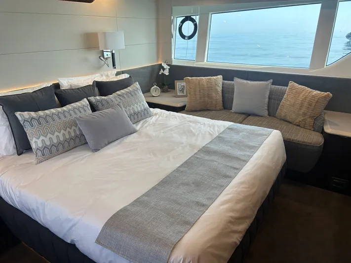Fairline Squadron Yacht Photos Pics Luxurious bedroom interior of 2024 Fairline Squadron 68 yacht with ocean view.