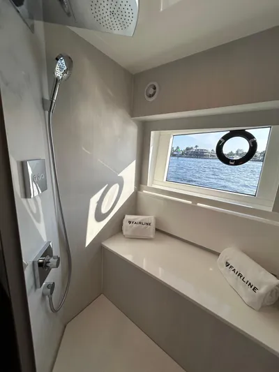 Fairline Squadron Yacht Photos Pics 2024 Fairline Squadron 68 yacht bathroom with modern shower and window view.