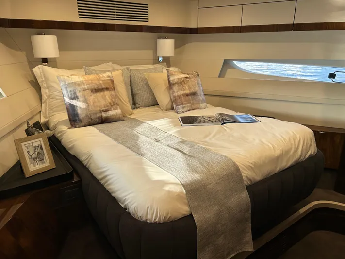 Fairline Squadron Yacht Photos Pics Luxurious bedroom interior of 2024 Fairline Squadron 68 yacht with elegant bedding and decor.