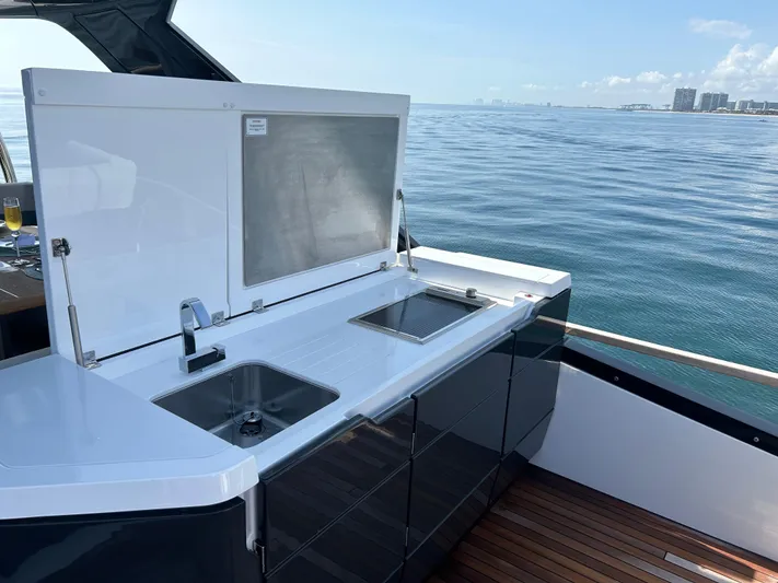 Fairline Squadron Yacht Photos Pics 2024 Fairline Squadron 68 yacht with sleek outdoor kitchen and ocean view.