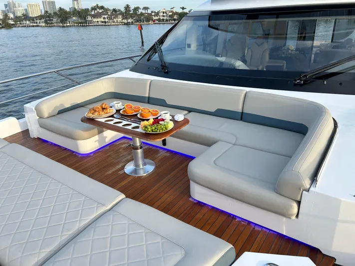 Fairline Squadron Yacht Photos Pics Luxurious 2024 Fairline Squadron 68 yacht deck with elegant seating and breakfast setup.