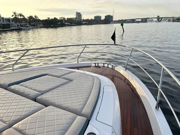 Fairline Squadron Yacht Photos Pics 2024 Fairline Squadron 68 yacht with luxurious deck, cruising on calm waters at sunset.