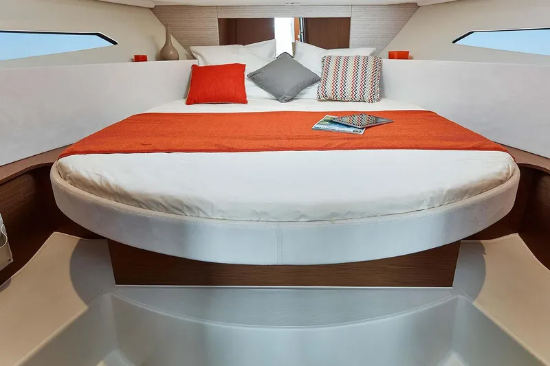  Yacht Photos Pics Manufacturer Provided Image: 2018 Jeanneau NC 9 boat interior with cozy bed and vibrant orange accents.