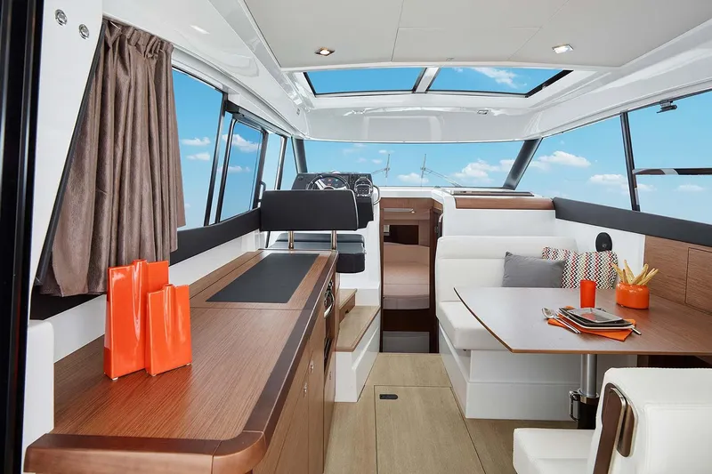  Yacht Photos Pics Manufacturer Provided Image: 2018 Jeanneau NC 9 interior with modern kitchen and dining area.