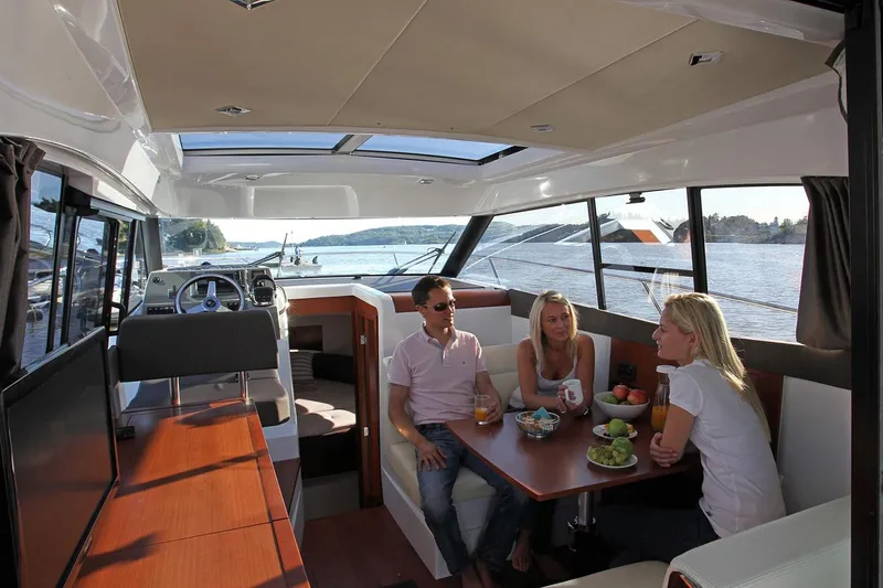  Yacht Photos Pics Manufacturer Provided Image: People enjoying a meal inside a 2018 Jeanneau NC 9 boat.