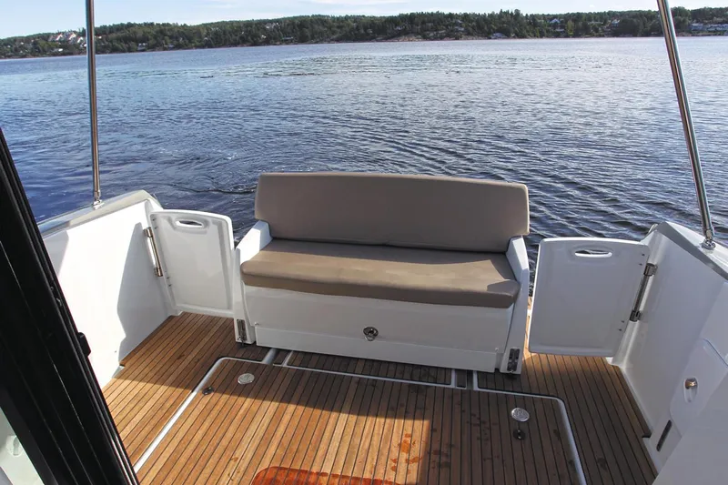  Yacht Photos Pics Manufacturer Provided Image: 2018 Jeanneau NC 9 boat with rear deck seating and scenic water view.