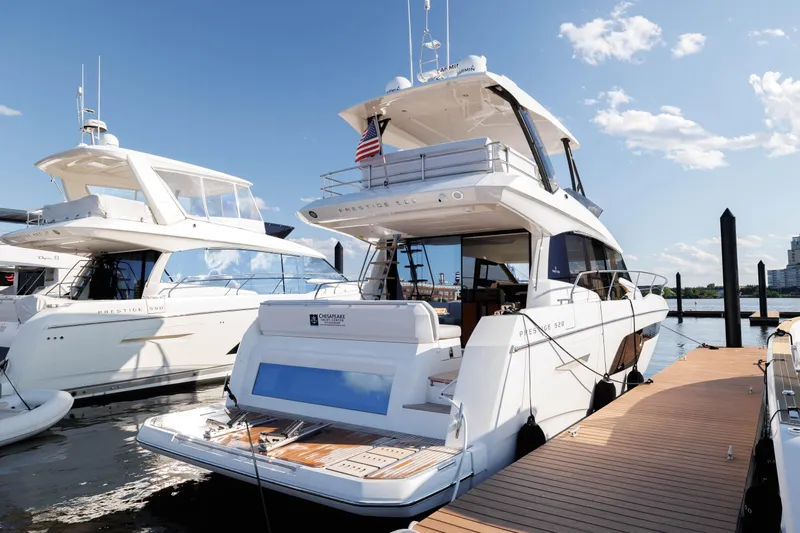  Yacht Photos Pics 2024 Prestige 520 yacht docked at marina under clear blue sky.