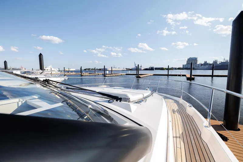  Yacht Photos Pics Prestige 520 yacht 2024 model docked at marina, clear sky, calm water.