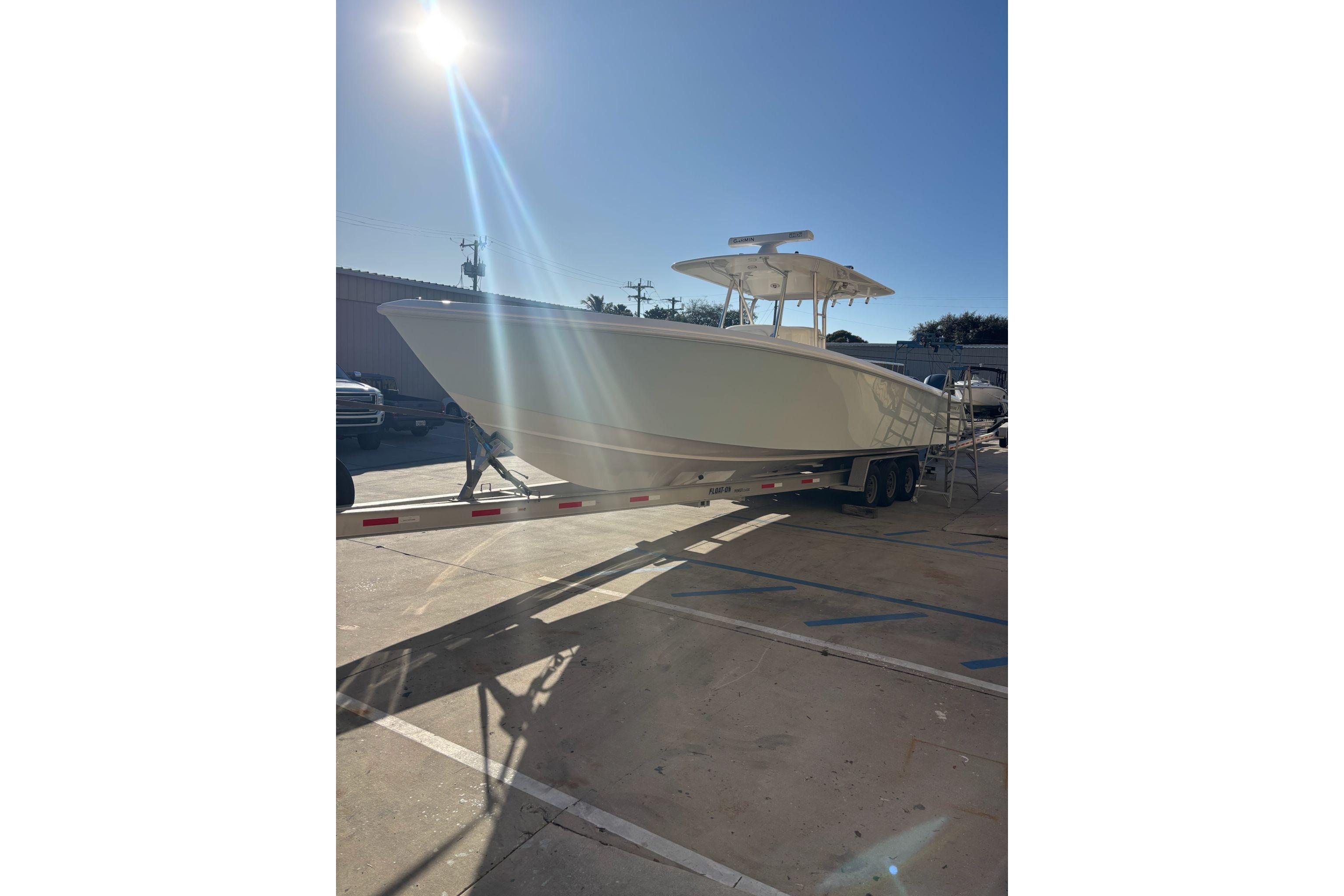 2017 Venture 39 Open boat on trailer under bright sunlight.
