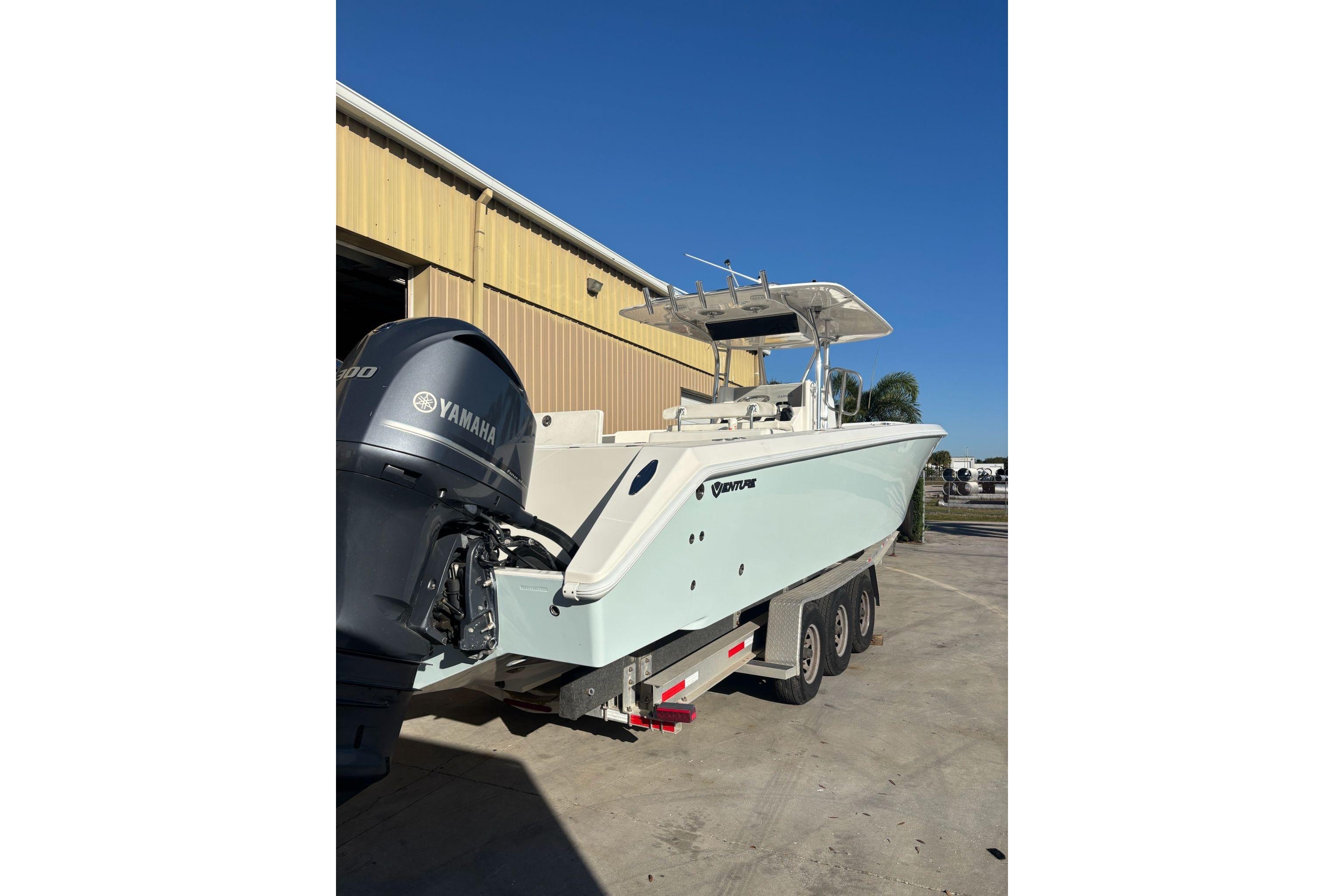 2017 Venture 39 Open boat with Yamaha engine on trailer, parked outdoors.