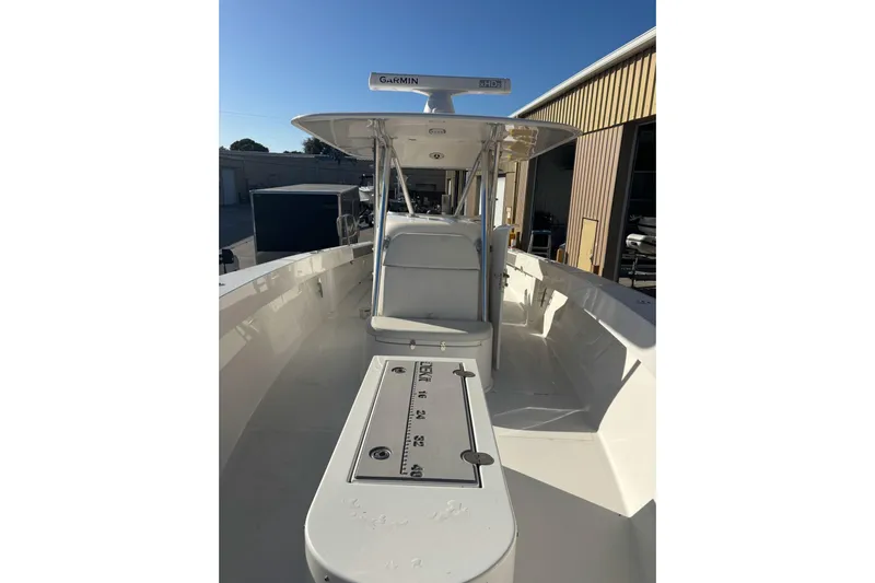  Yacht Photos Pics 2017 Venture 39 Open boat with Garmin equipment, docked near a warehouse.