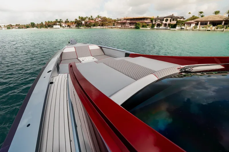 Mana Yacht Photos Pics 2025 Maori 54XL luxury yacht on serene water near coastal homes.