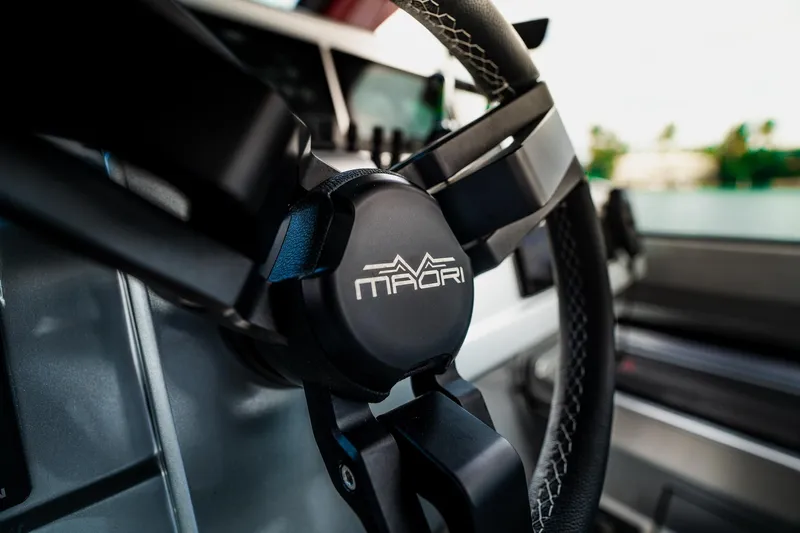 Mana Yacht Photos Pics Close-up of Maori 54XL 2025 steering wheel, showcasing sleek design and logo.