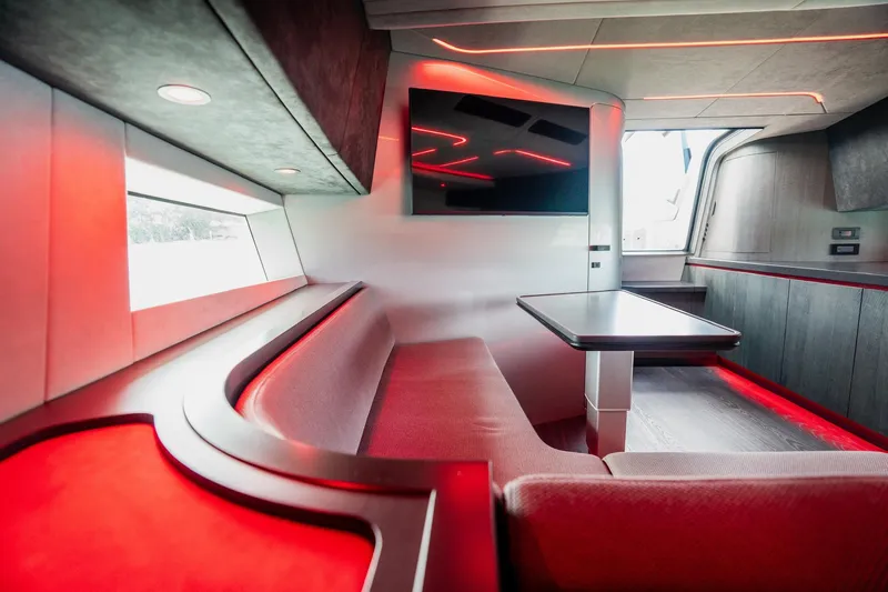 Mana Yacht Photos Pics Futuristic interior of 2025 Maori 54XL yacht with red LED lighting and modern seating.