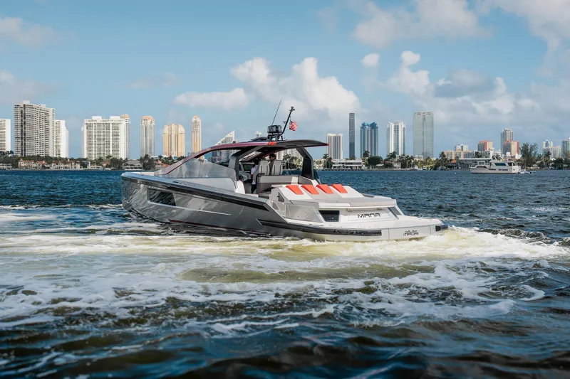 Mana Yacht Photos Pics Luxury Maori 54XL yacht cruising near city skyline, 2025 model.