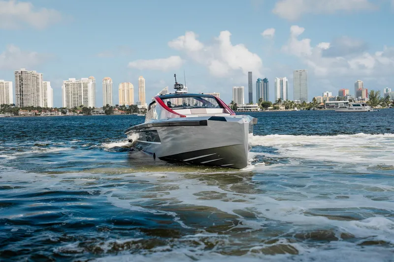 Mana Yacht Photos Pics Luxury Maori 54XL yacht cruising near city skyline, 2025 model.