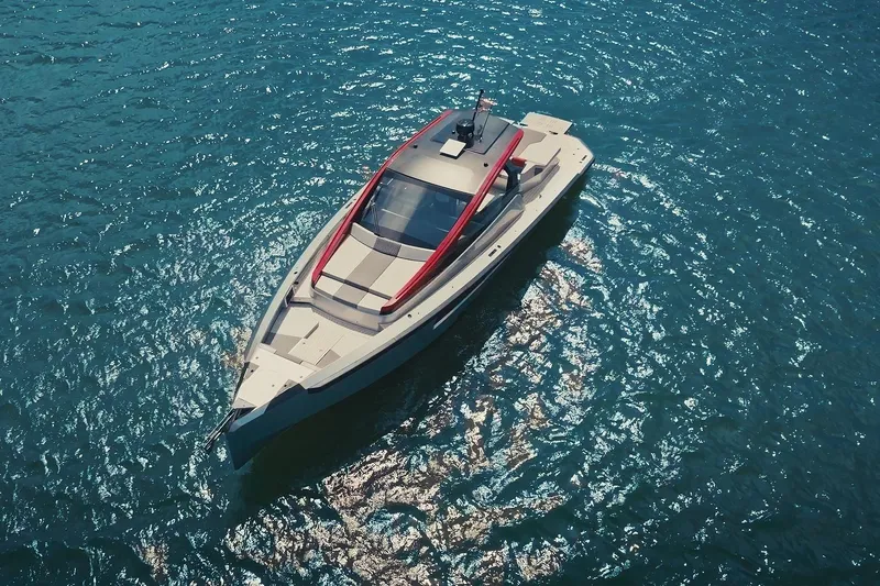 Mana Yacht Photos Pics Aerial view of 2025 Maori 54XL yacht on sparkling blue water.