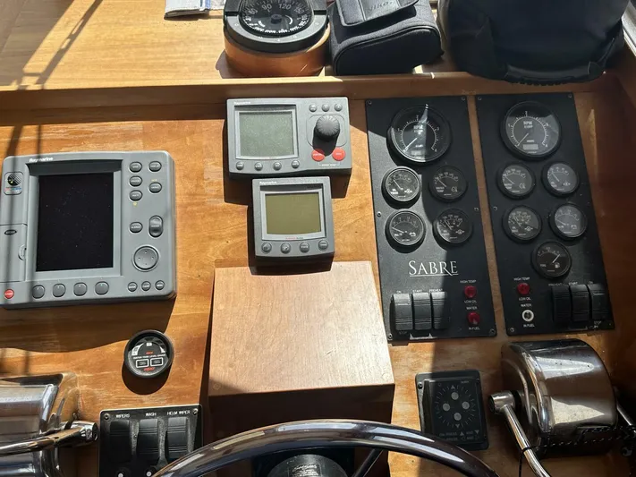 Blue Goose Yacht Photos Pics Control panel of 2003 Sabre 36 Fly Bridge Sedan with gauges and navigation equipment.