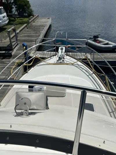 Blue Goose Yacht Photos Pics 2003 Sabre 36 Fly Bridge Sedan docked, view from bow, with water and dock in background.