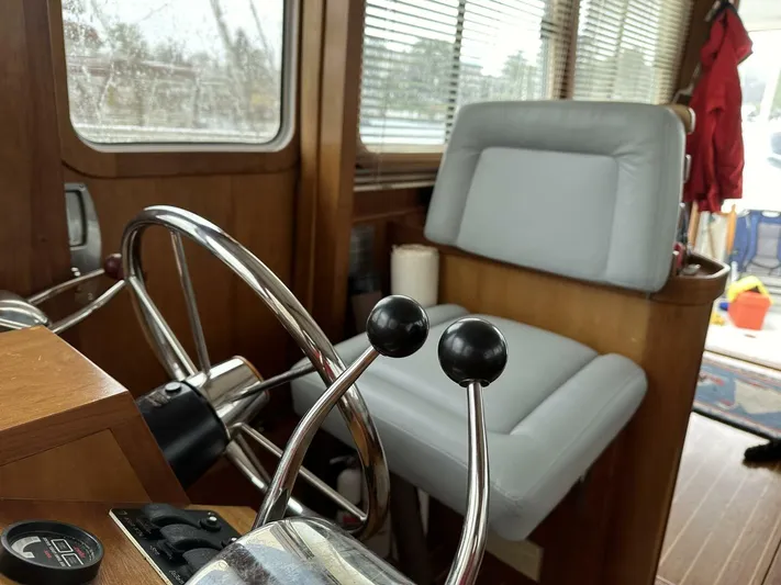 Blue Goose Yacht Photos Pics Interior of 2003 Sabre 36 Fly Bridge Sedan with steering wheel and captain's chair.