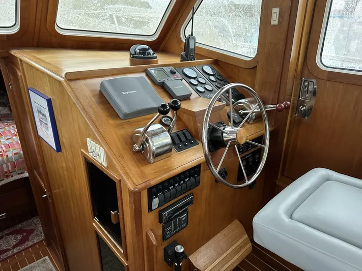 Blue Goose Yacht Photos Pics 2003 Sabre 36 Fly Bridge Sedan helm with wooden dashboard and steering wheel.