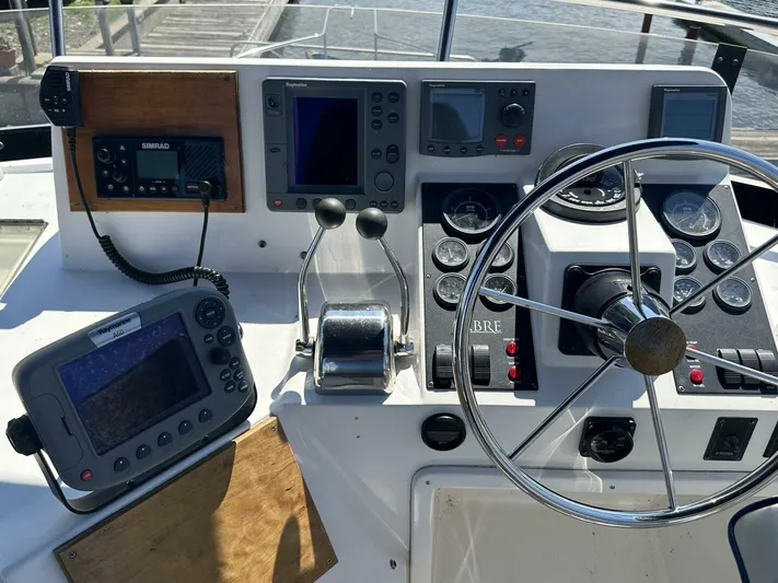 Blue Goose Yacht Photos Pics 2003 Sabre 36 Fly Bridge Sedan helm with navigation equipment and steering wheel.