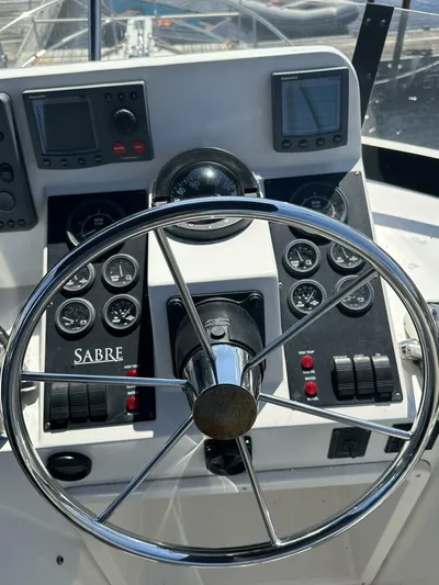 Blue Goose Yacht Photos Pics Steering wheel and dashboard of 2003 Sabre 36 Fly Bridge Sedan boat.
