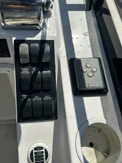 Blue Goose Yacht Photos Pics Control panel of 2003 Sabre 36 Fly Bridge Sedan with switches and cup holder.